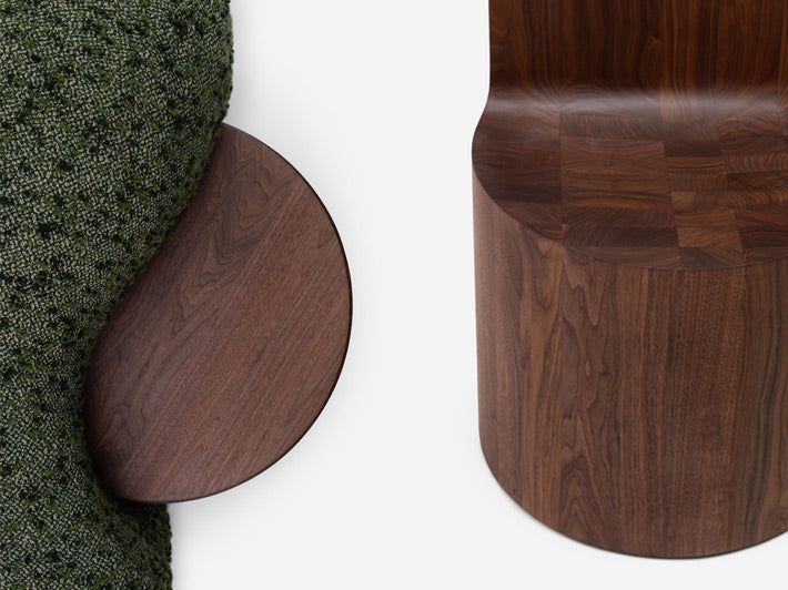 Wooden furniture pieces on a textured green surface.
